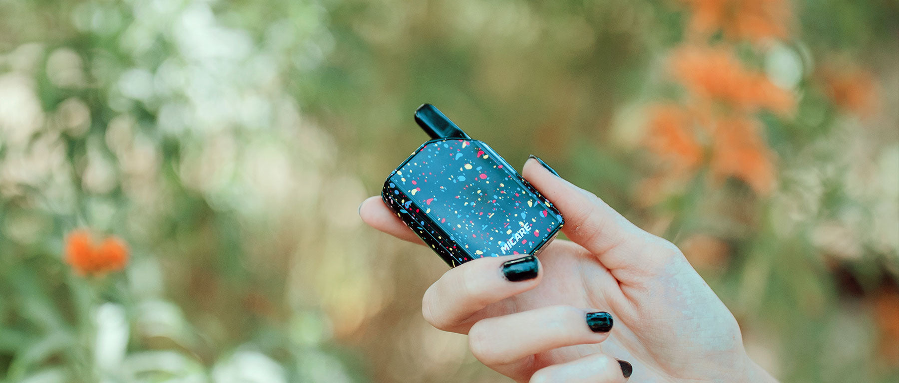 Woman holding Exxus Micare Vape Pen out in a nature park adventure