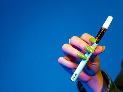 Woman holding Exxus M3B in front of blue studio background