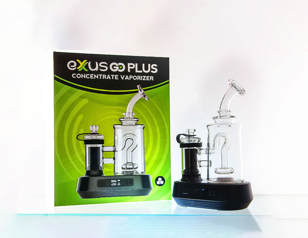 Exxus Go Plus vaporizer resting on reflective display with bright white lighting