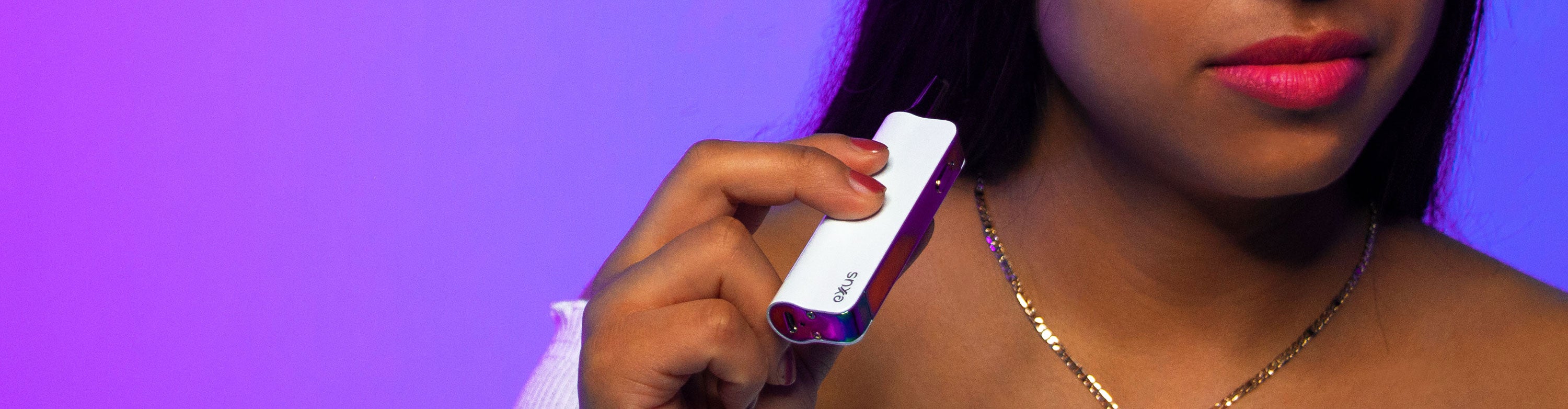 Woman holding Exxus Snap VV in front of purple and blue studio background