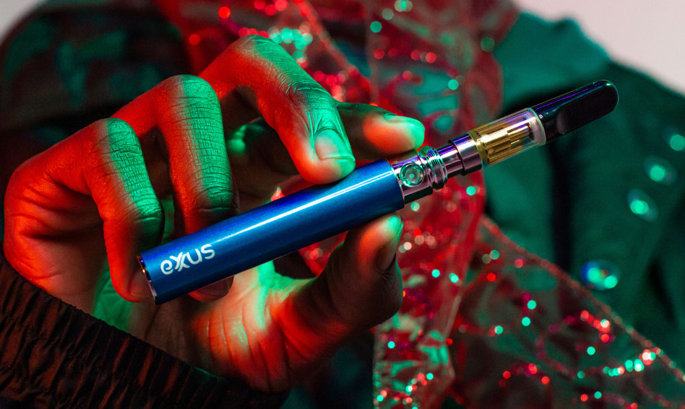 Man holding the Exxus 900 near Christmas decorations