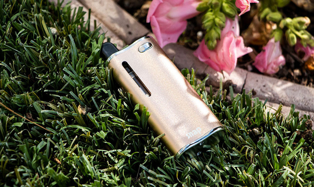 Cream coloured Exxus Snap 510 thread battery lying among pink flowers