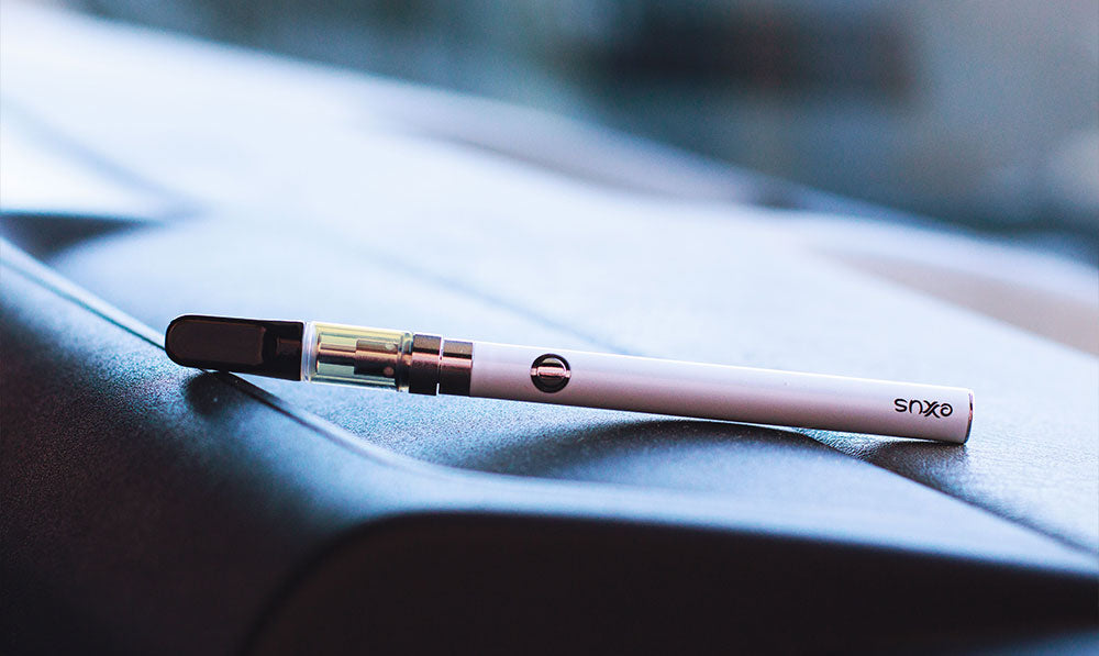 Exxus Slim VV 510 thread battery with a cartridge attached on a white cloth