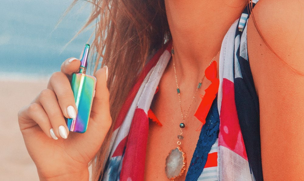 Exxus Snap VV Mini in woman's hands at the beach