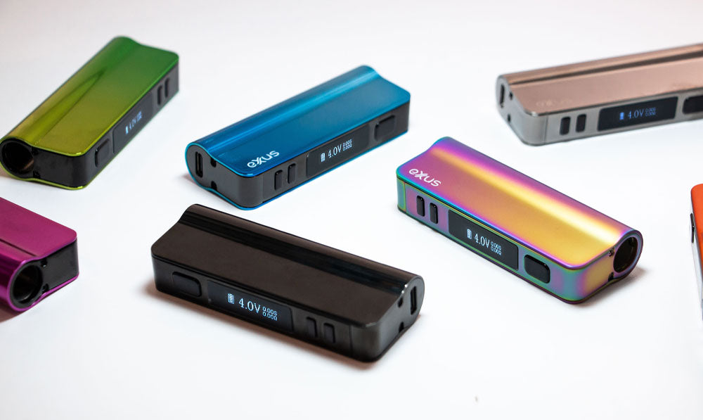 Exxus Snap VV Pro vaporizers resting on white display with bright lighting