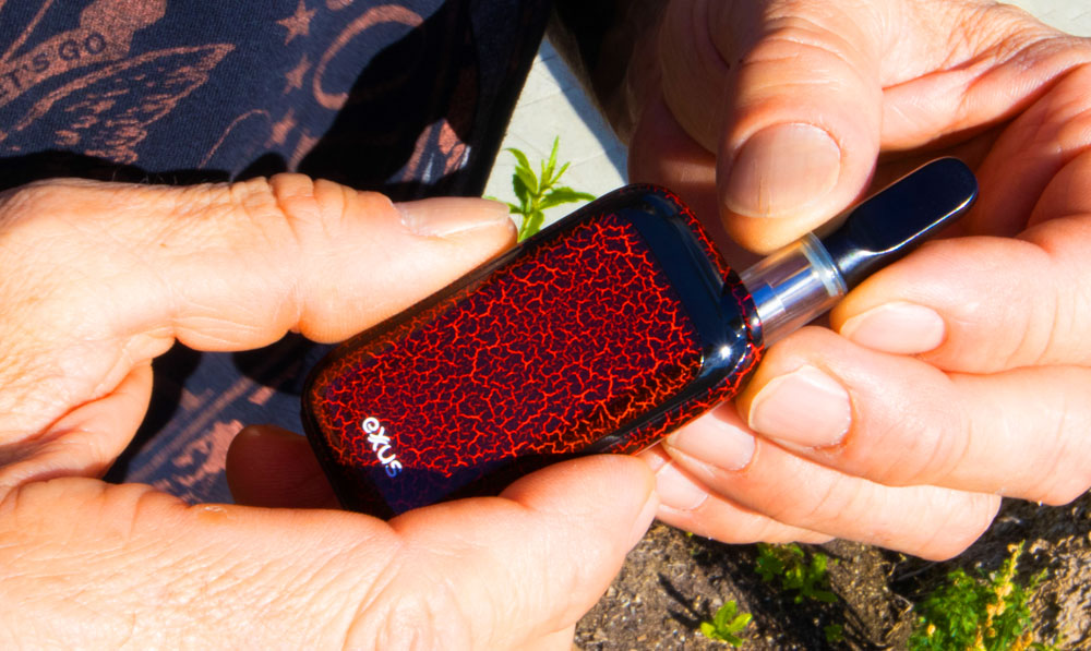 Man holding Exxus Rizo Crackle underneath natural sunlight