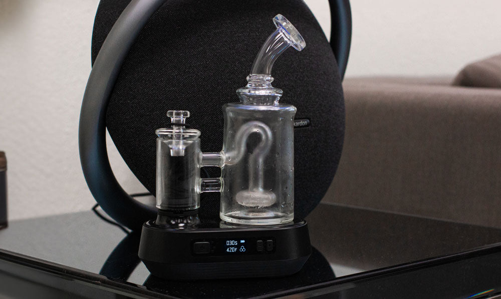 Exxus Go Plus resting on platform with speaker behind