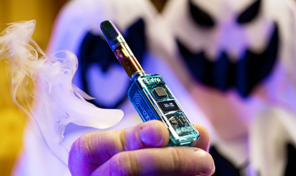 Exxus Claro held by man in ghost costume