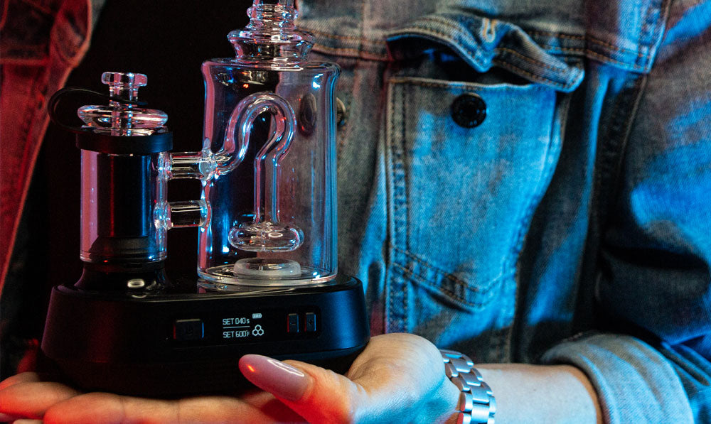 woman in denim jacket holding the Exxus Go Plus set to medium temperature