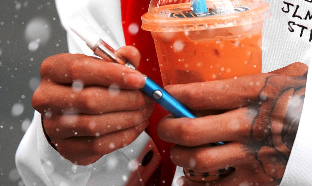 Man holding Plus VV 2 near drink with snow falling