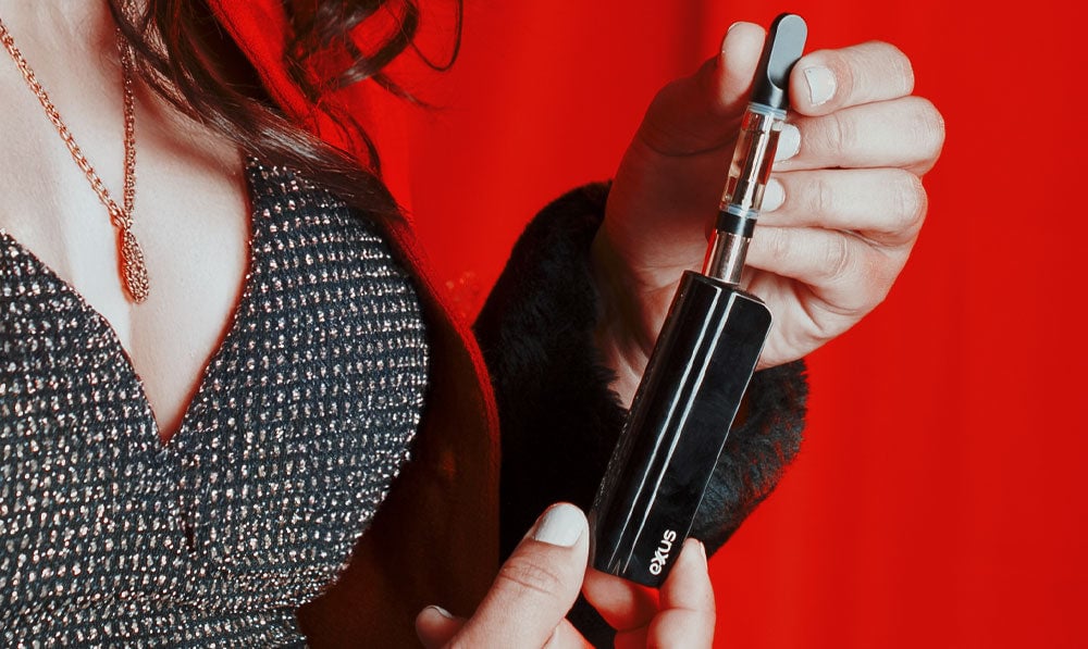 Woman holding Exxus Snap VV in front of red Santa themed photoshoot