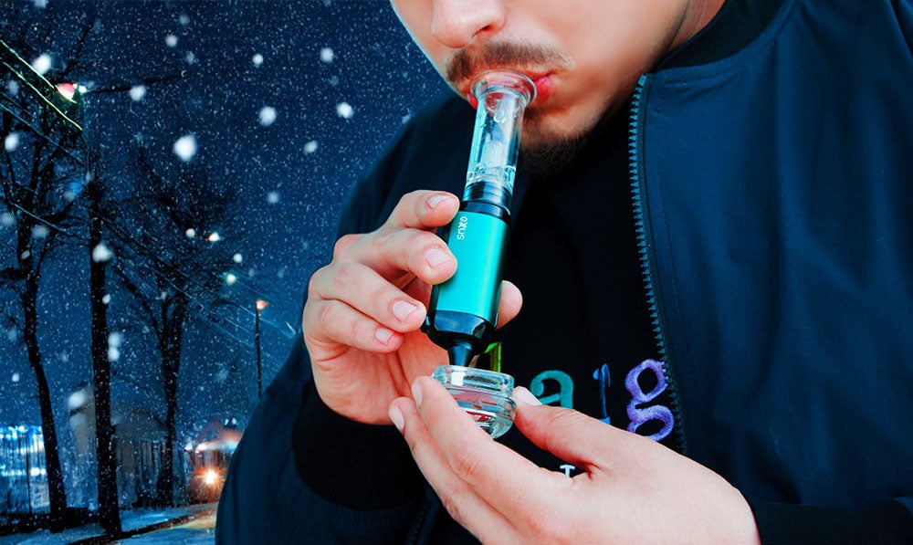 Man holding Exxus VRS close to jacket out in nighttime snowy street scene