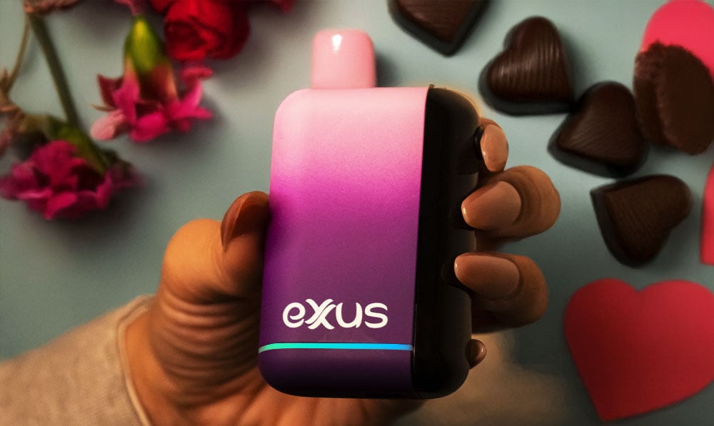 Woman holding Exxus Snap DLX over Valentine's Day chocolates and roses