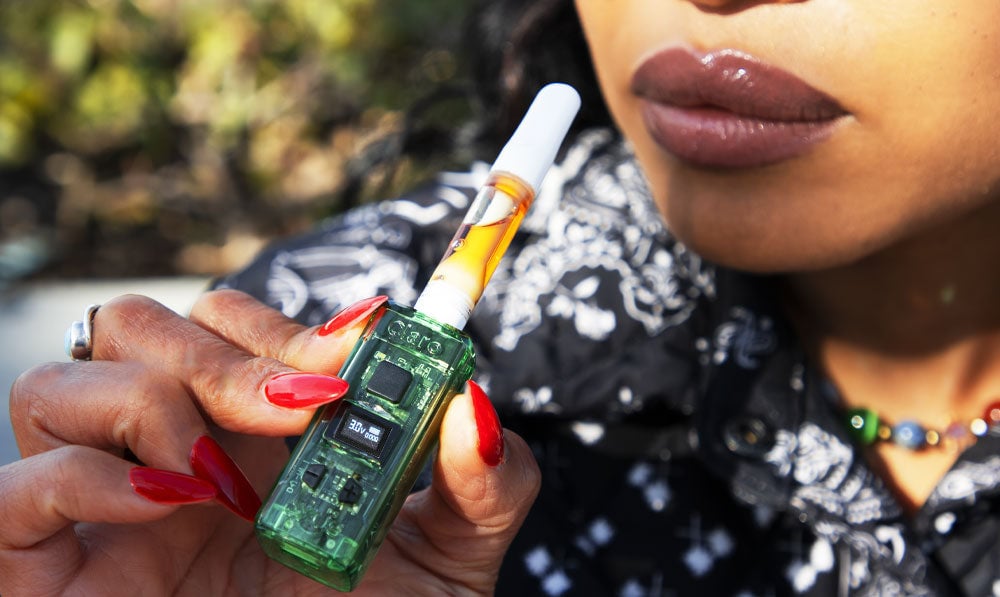 Woman holding Exxus Claro in a park