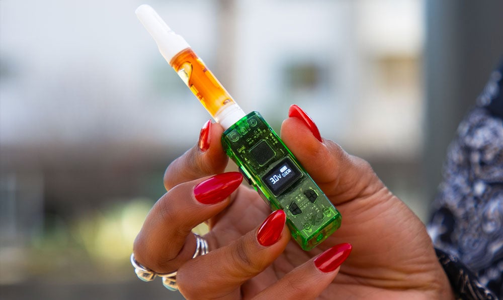 Woman holding Exxus Claro under sunlight