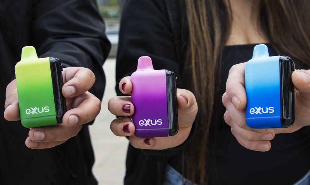 Group of people holding Exxus Snap DLX at park