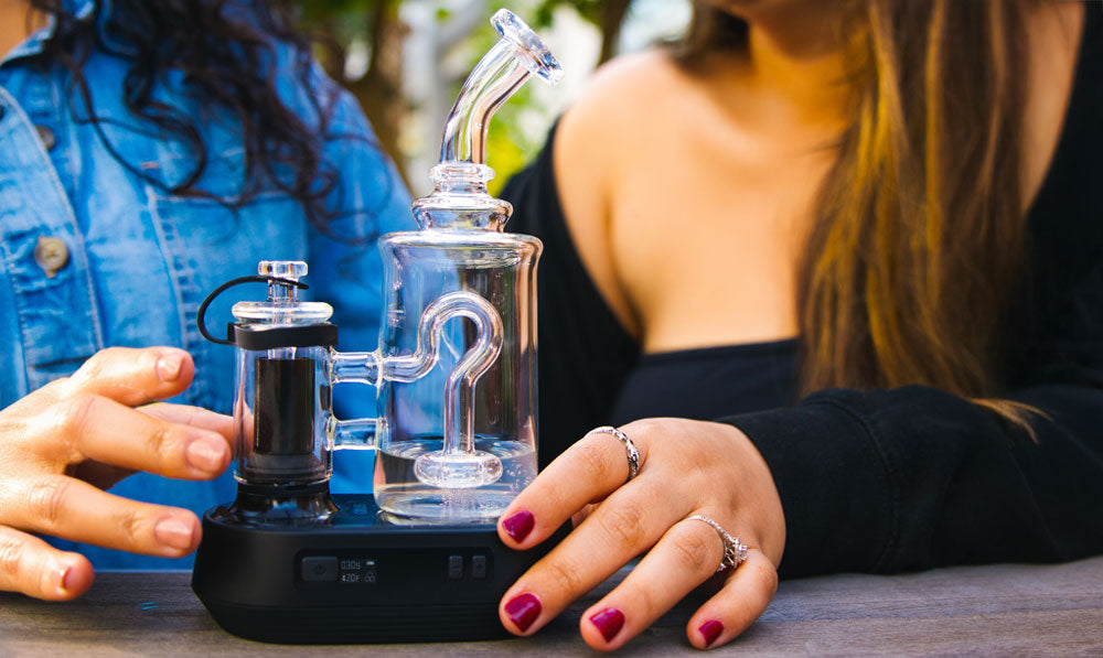 Two women with Exxus Go Plus on a park bench during spring