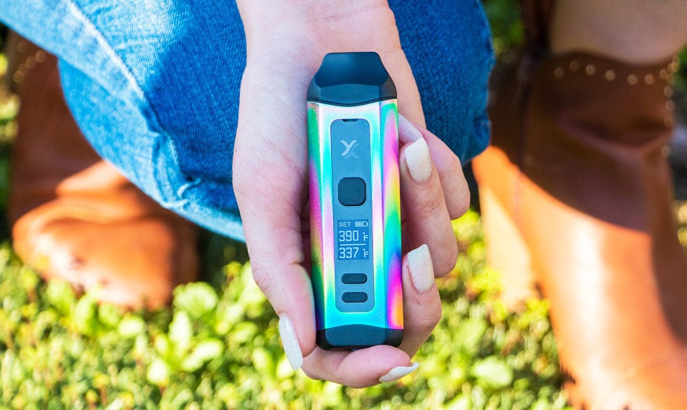 Woman kneeling with Exxus Mini Plus in hand