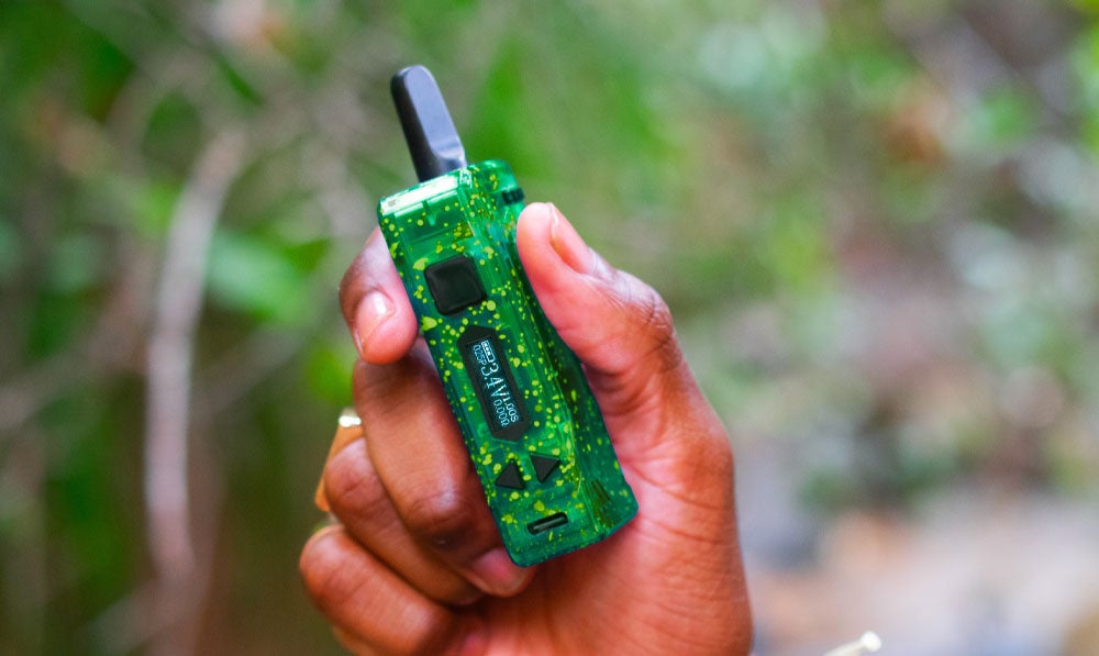 Man holding Exxus Adapt at a park trail