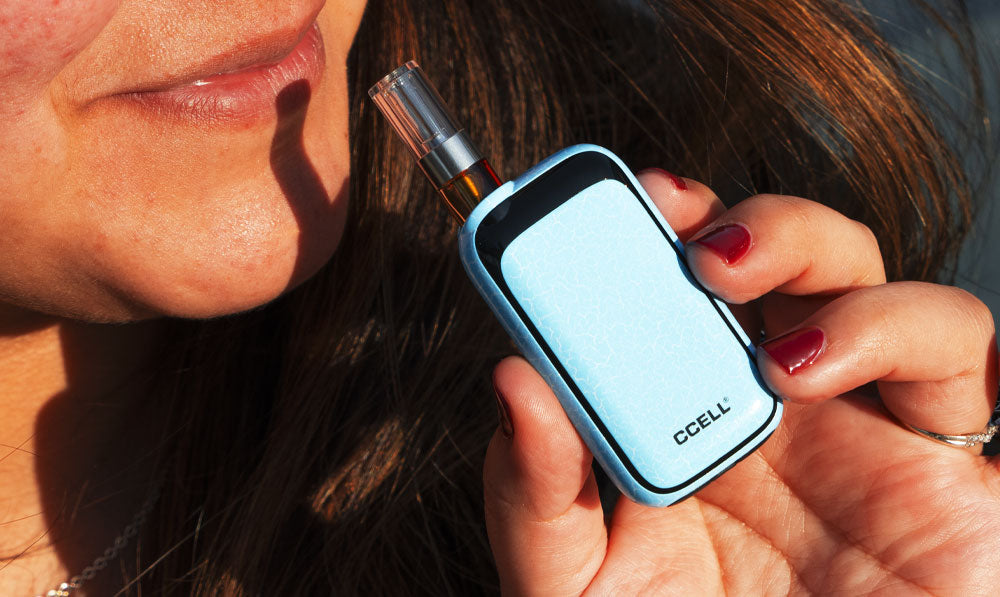Woman holding Exxus Rizo near mouth