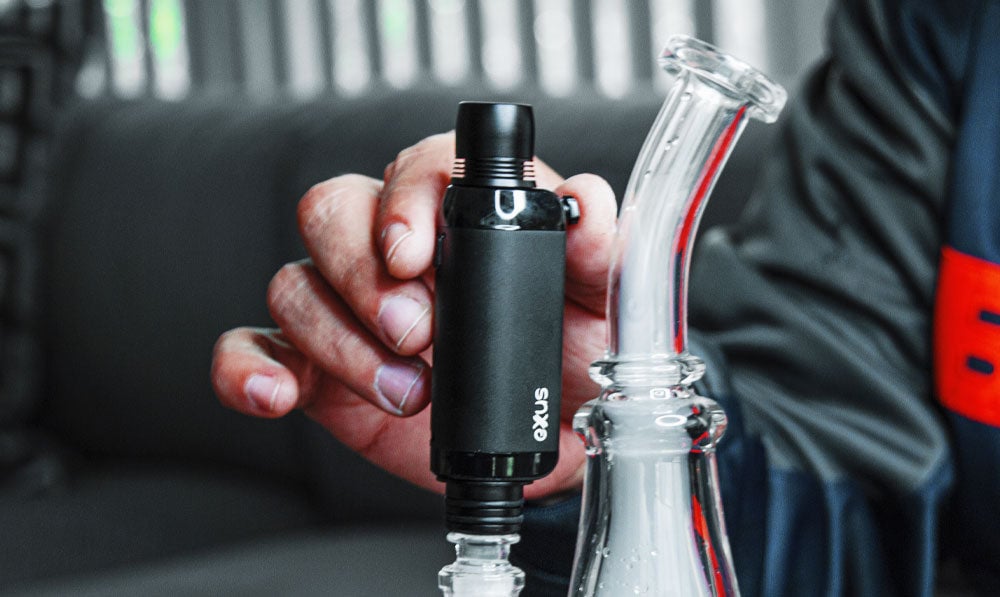 Man in a bomber jacket using Exxus VRS with a waterpipe