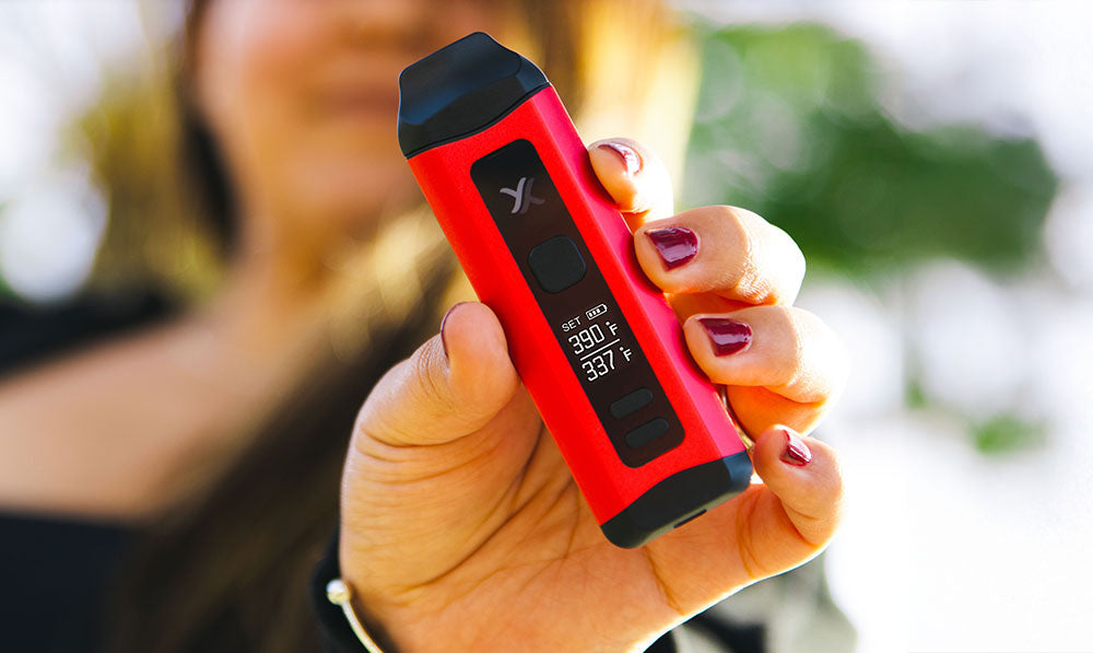 woman holding Exxus Mini Plus at park