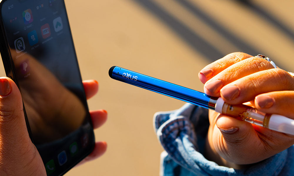 woman using Exxus Slim 2.0 with stylus on phone