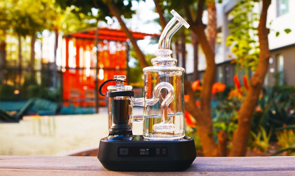 Exxus Go Plus on park table with trees in the background