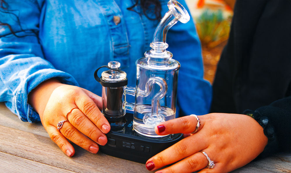 Two women holding Exxus Go Plus on bench