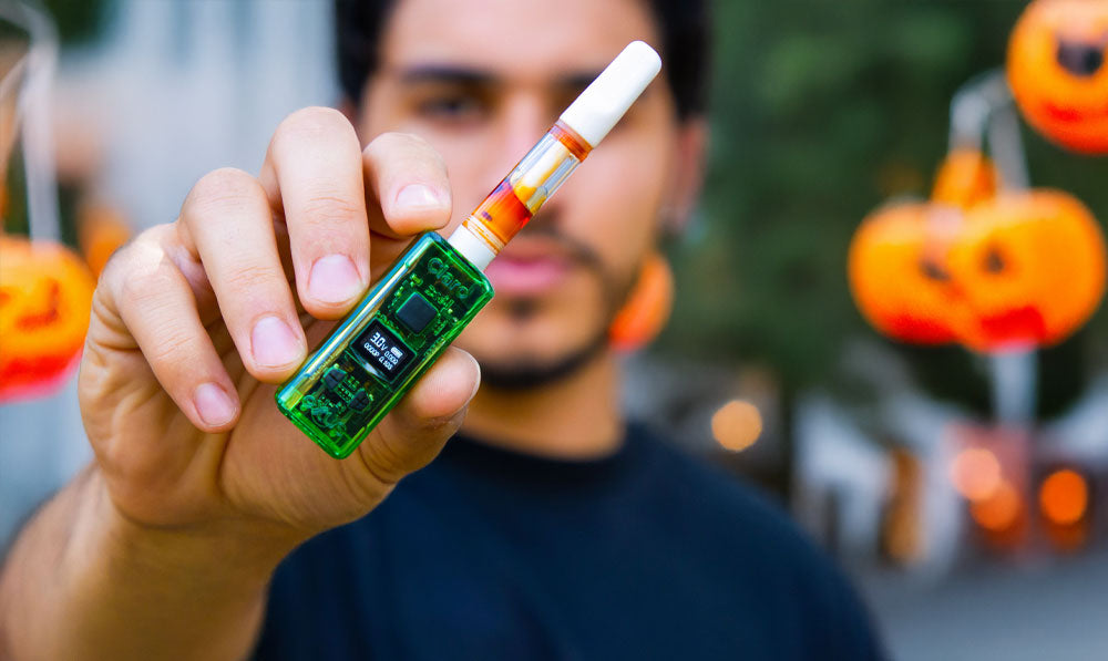 Man holding Exxus Claro in street decorated for Halloween