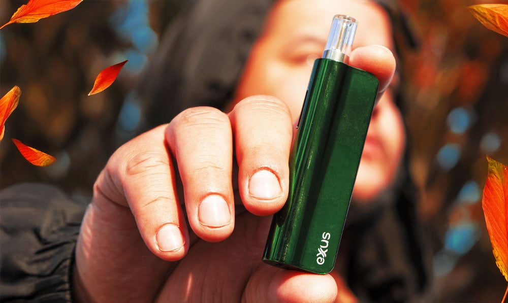 Man holding Exxus Snap VV with autumn leaves falling