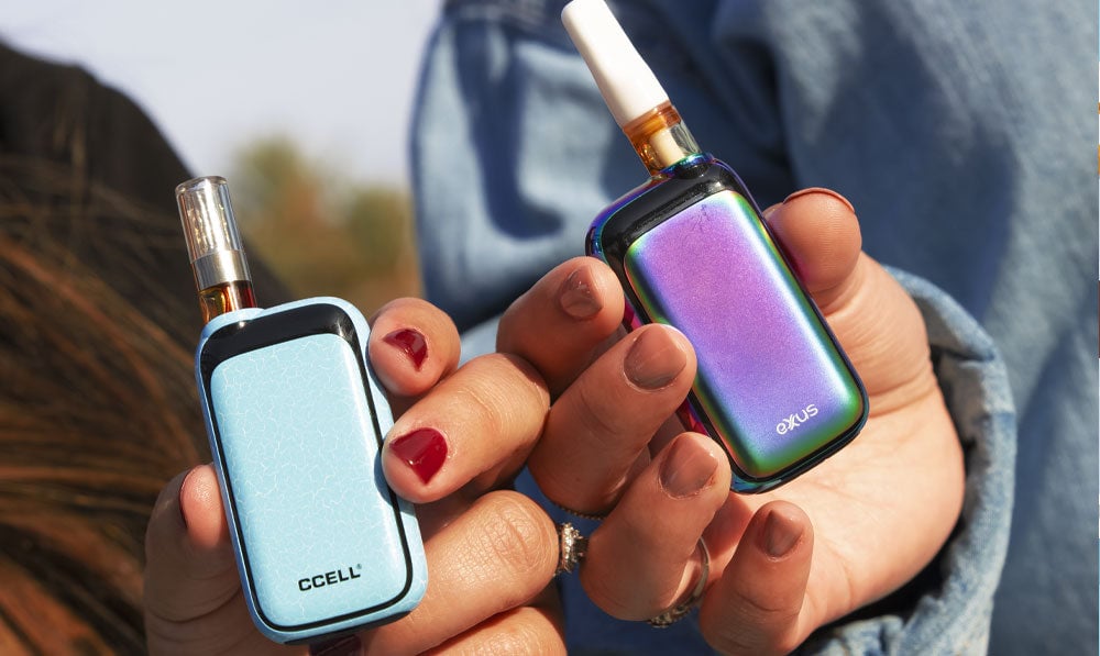 Two people holding Rizo 510 thread batteries