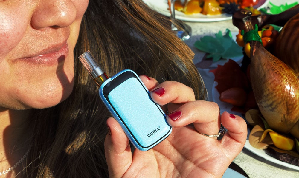 Woman holding Exxus Rizo over Thanksgiving dinner