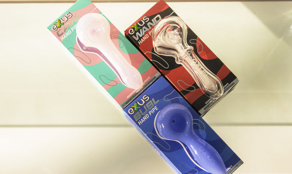 Exxus glass hand pipes stacked together in their retail packaging