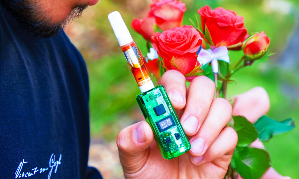 Man holding Exxus Claro with roses nearby