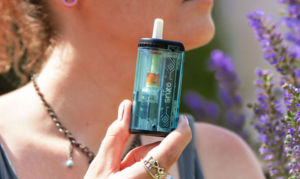 Woman holding Exxus Adapt around springtime flowers