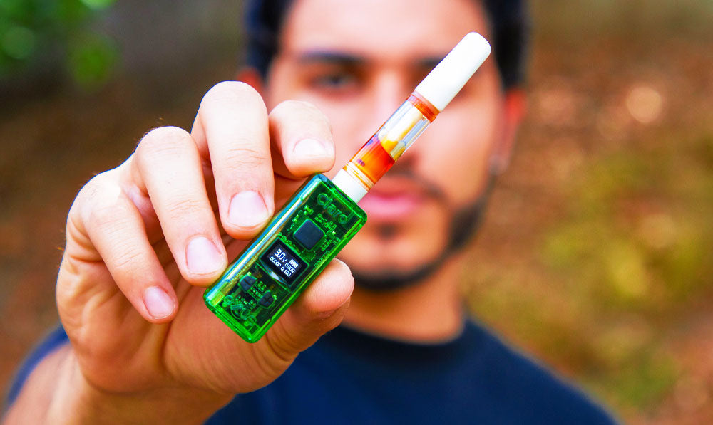 Man on a nature trail holding Exxus Claro up