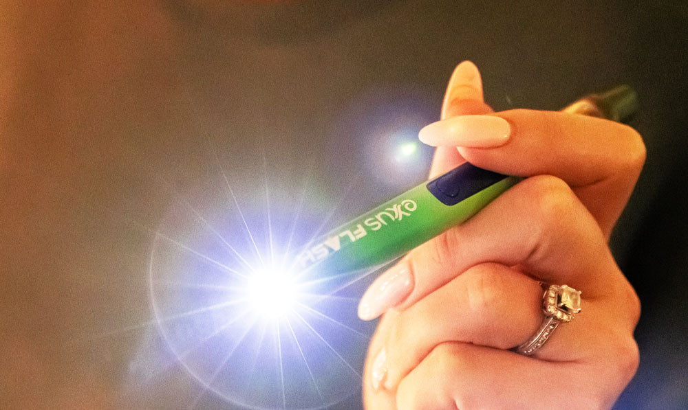 Woman holding Exxus Flash with flashlight on
