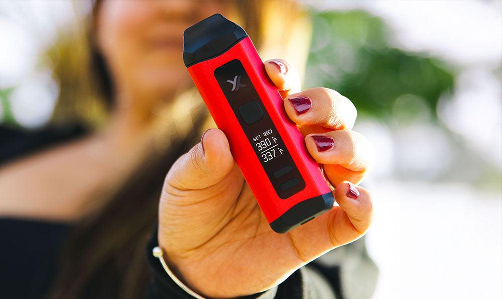 woman showing off the Exxus Mini Plus at park