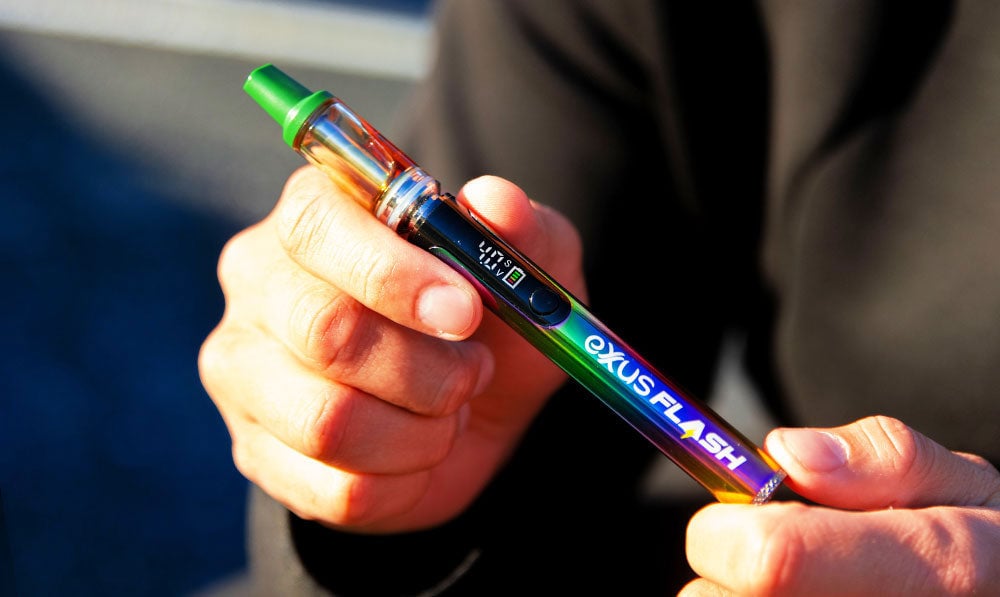 man holding the Exxus Flash 510 battery outside