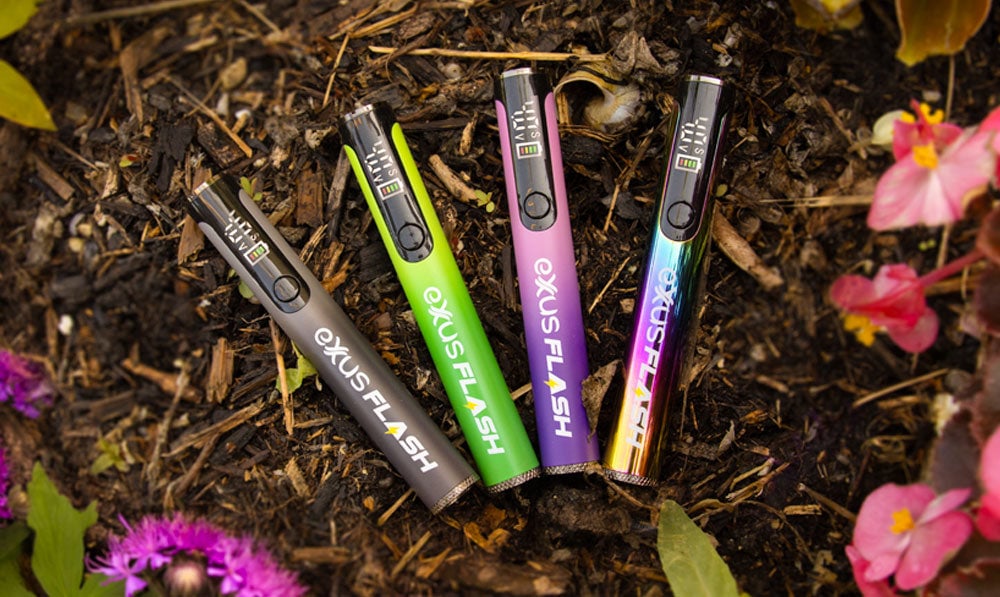 Exxus Flash Vape on ground surrounded my floral background scenery with 4 color variations