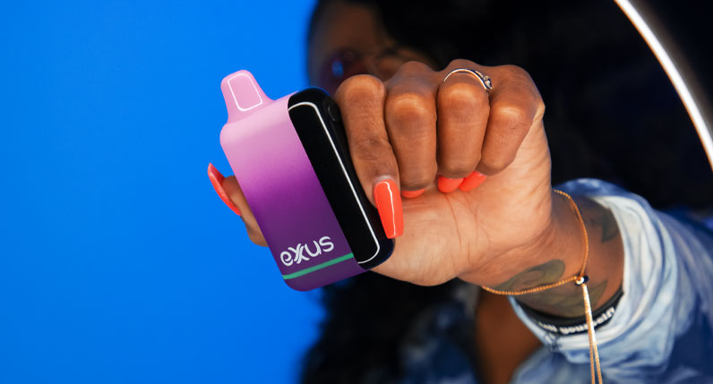 Woman holding Exxus Snap DLX in front of blue studio background