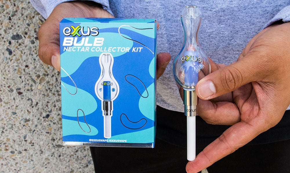 man holding the Exxus Bulb Nectar Collector with box