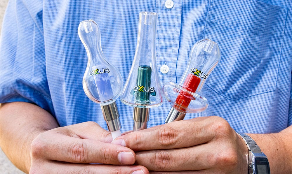 man holding Exxus Nectar collectors