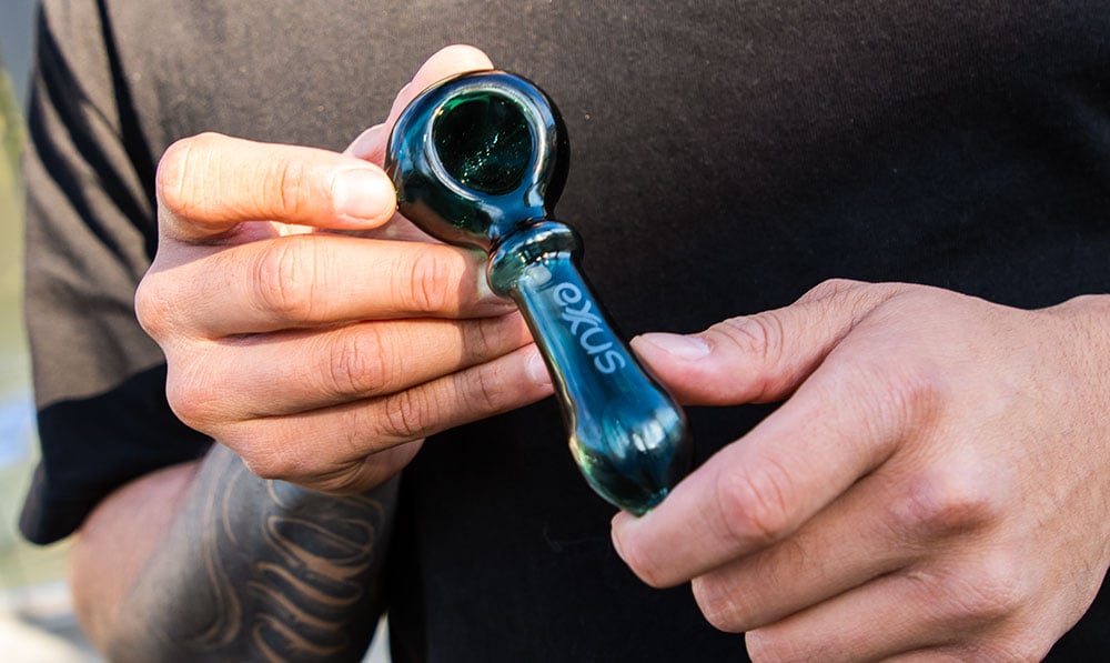 man holding the Exxus Wand hand pipe
